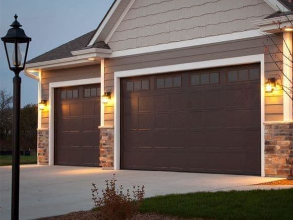 Home with 3-car garage and brown garage doors.