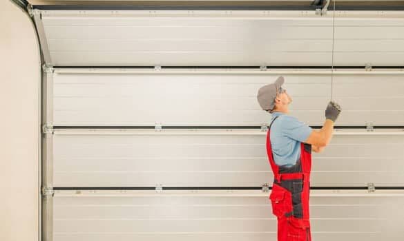 A garage door technician installing a new garage door.