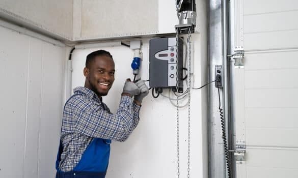 A professional garage door technician performs a garage door installation.