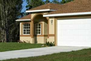 Brown and yellow home with new white garage door
