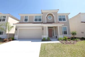 Two-story beige Florida home with matching garage door
