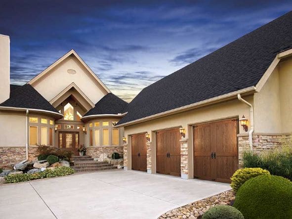Upscale suburban home with 3-car garage and faux wood garage doors