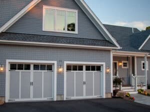Blue suburban home with two garage doors